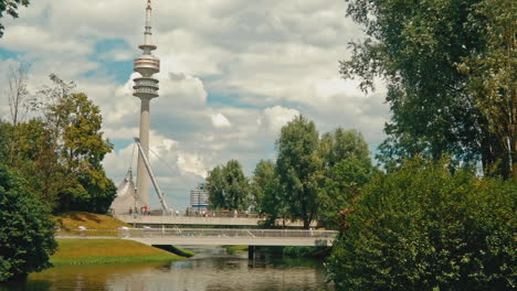 Wide-shot-of-racing-cyclists-crossing-a-bridge