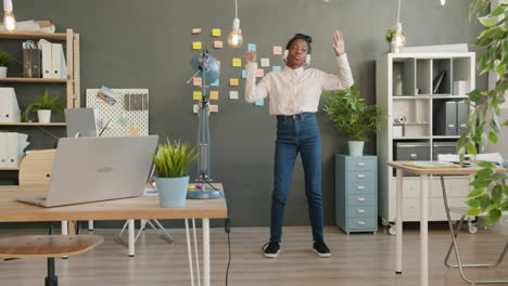 young woman dancing in modern office