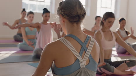 yoga class of beautiful women practice easy pose forward bend enjoying healthy lifestyle exercising in fitness studio instructor teaching group meditation at sunrise