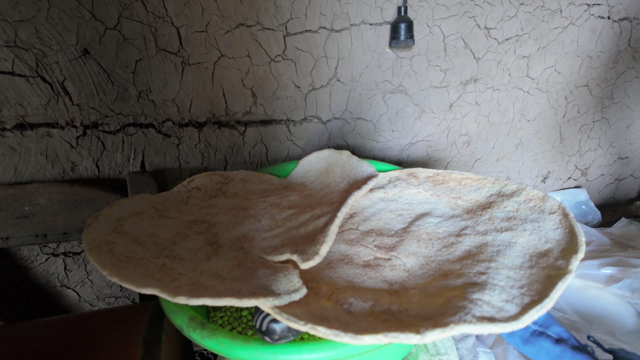 Two fresh, homemade cassava tortillas resting on a plate in a rustic, authentic setting