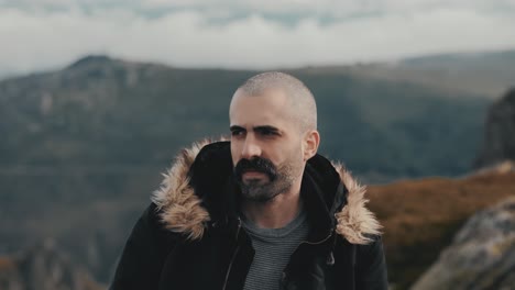 slow motion shot of man exploring the beauty of the mountains on a cold day