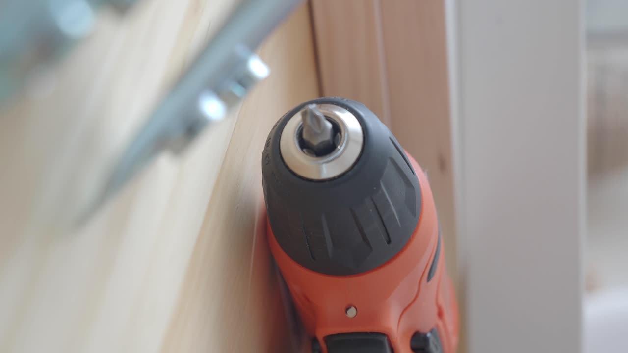 Close-up of an electric screwdriver on wood