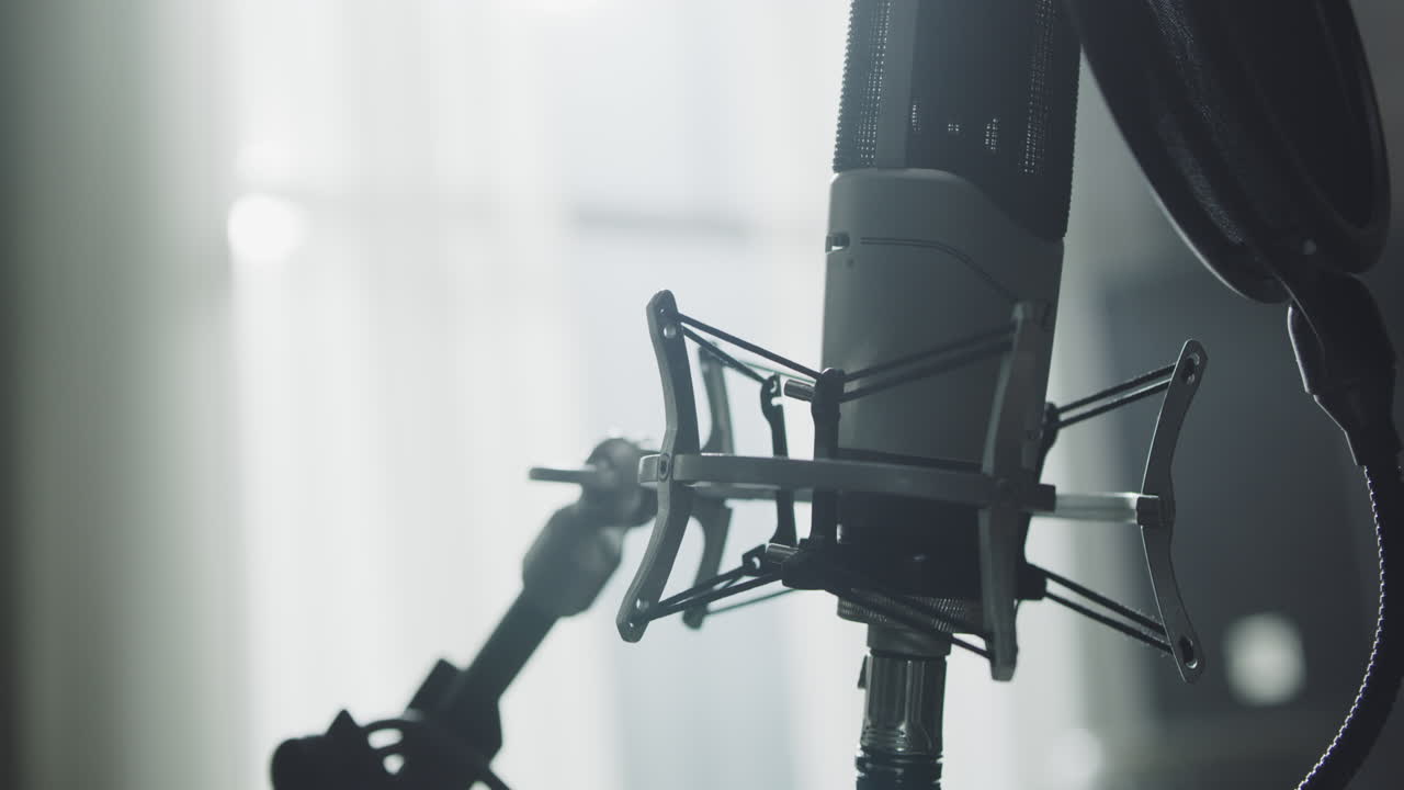 Professional microphone for dubbing and voice over in the sound recording studio. Close up, podcasting concept
