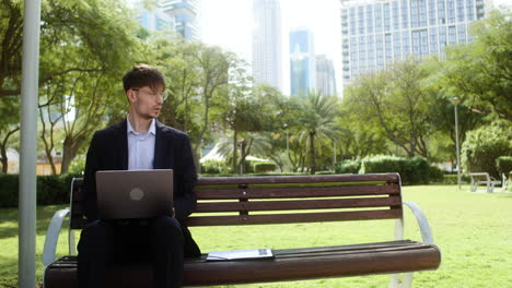 man sitting on the bench of a park