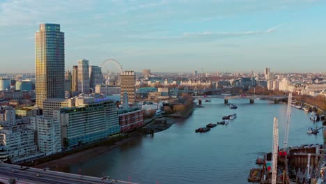 Aerial-dolly-forward-drone-shot-over-Blackfriars-towards-thames-river-London-eye-Westminster-sunrise