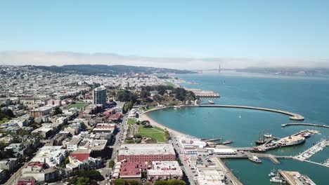 Aerial-dolly-view-of-Municipal-Pier-with-Golden-Gate-Bridge-in-background