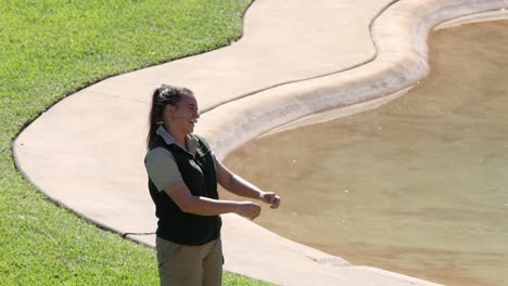 zoo staff member presenting near water feature