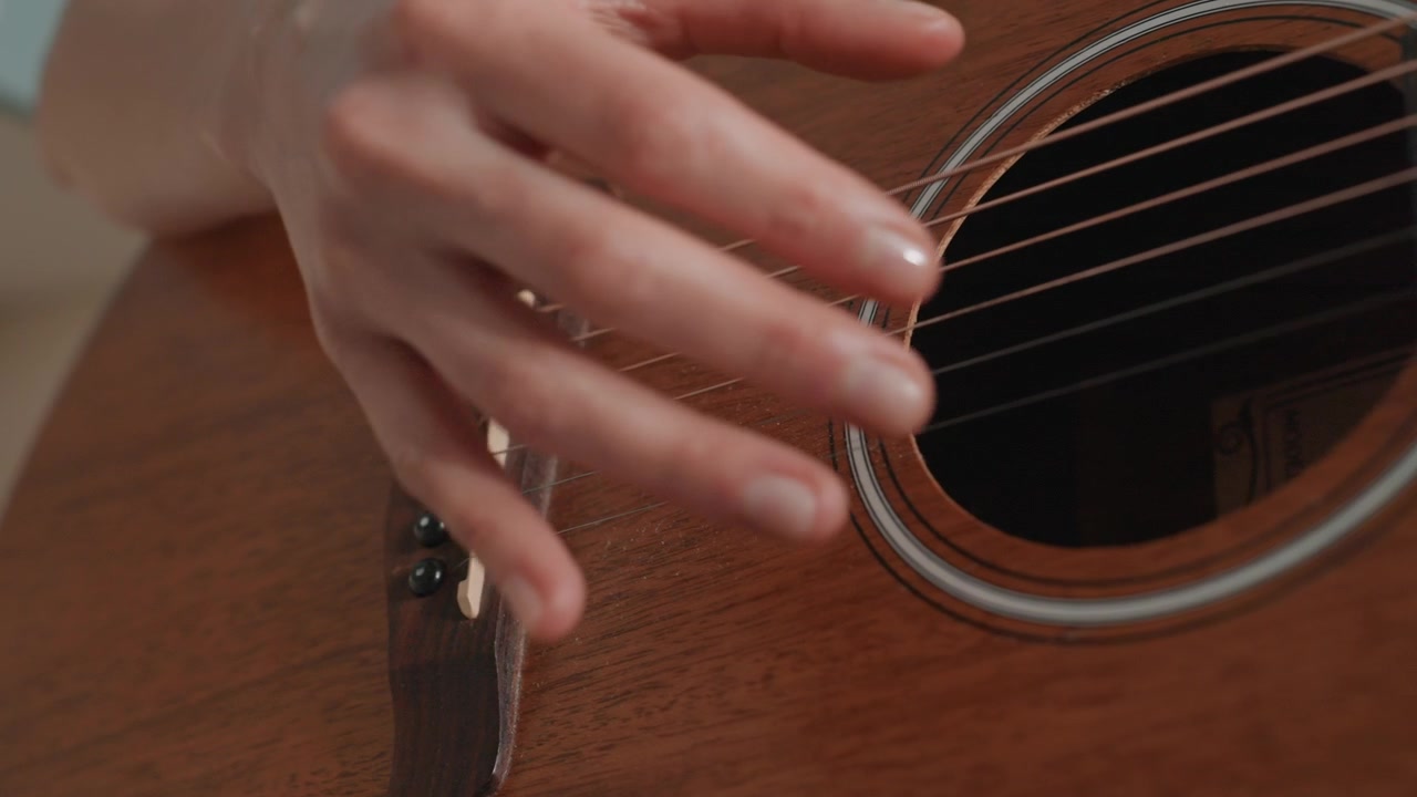 Closeup hands fingerpicking acoustic guitar, warm wood body, soft natural light, slow expressive tempo, right hand technique focus, gentle nails, home practice session, cozy studio atmosphere, tender
