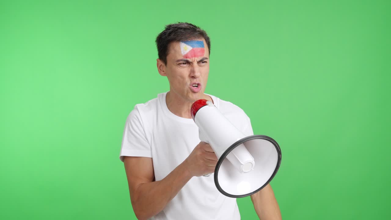 Excited man with philippine flag on face using a megaphone
