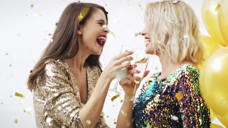 woman drinking champagne and dancing among confetti