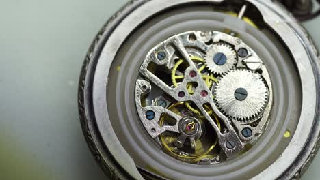 old pocket watch mechanism working, close up view