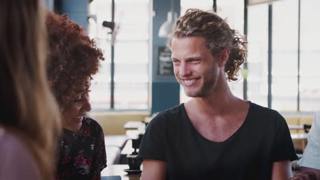 Group-Of-Young-Friends-Meeting-And-Talking-In-Coffee-Shop