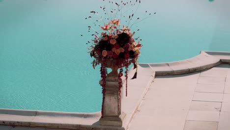 Static-shot-of-a-bouquet-of-flowers-beside-a-pool-as-a-decoration-at-a-wedding