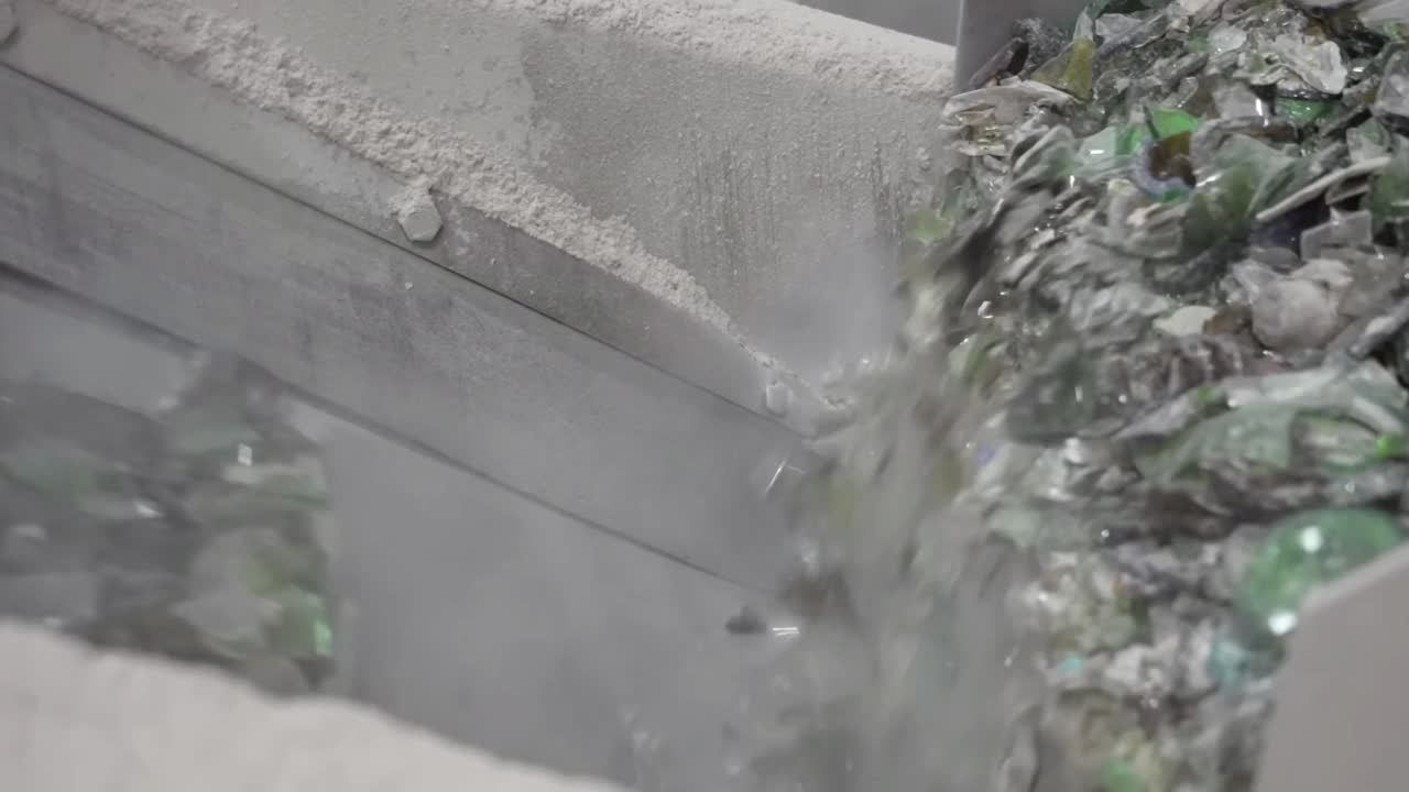 Conveyor full of used plastic bottles falling down.