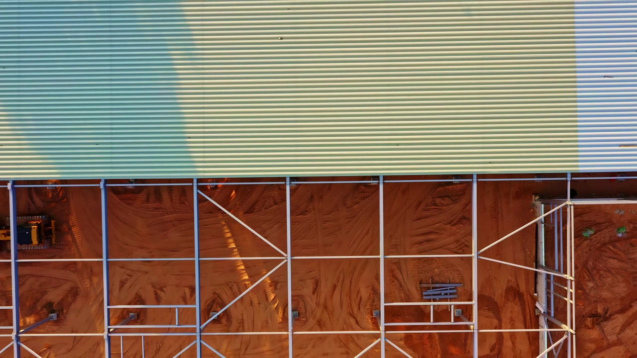 Industrial building framework for a warehouse showing steel construction, aerial top view