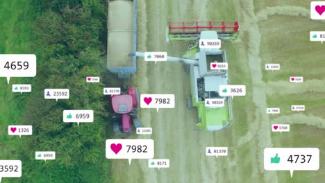 combine harvester unloading grain into red tractor trailer in top-down view, social media icons