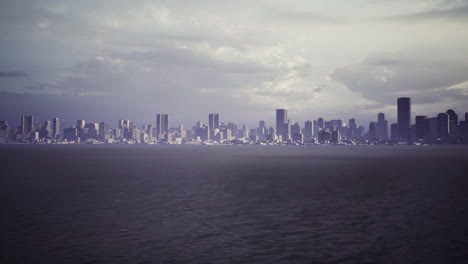 skyline at dusk with dramatic clouds over the coastal waterfront