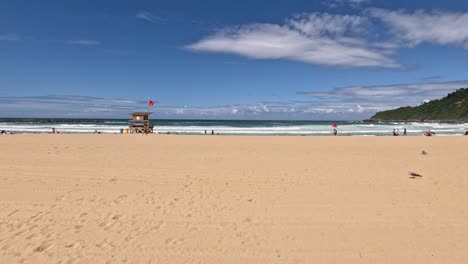 beach goers enjoy expansive sand beach in sunny san sebastian, spain