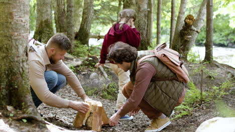 family holding logs for campfire