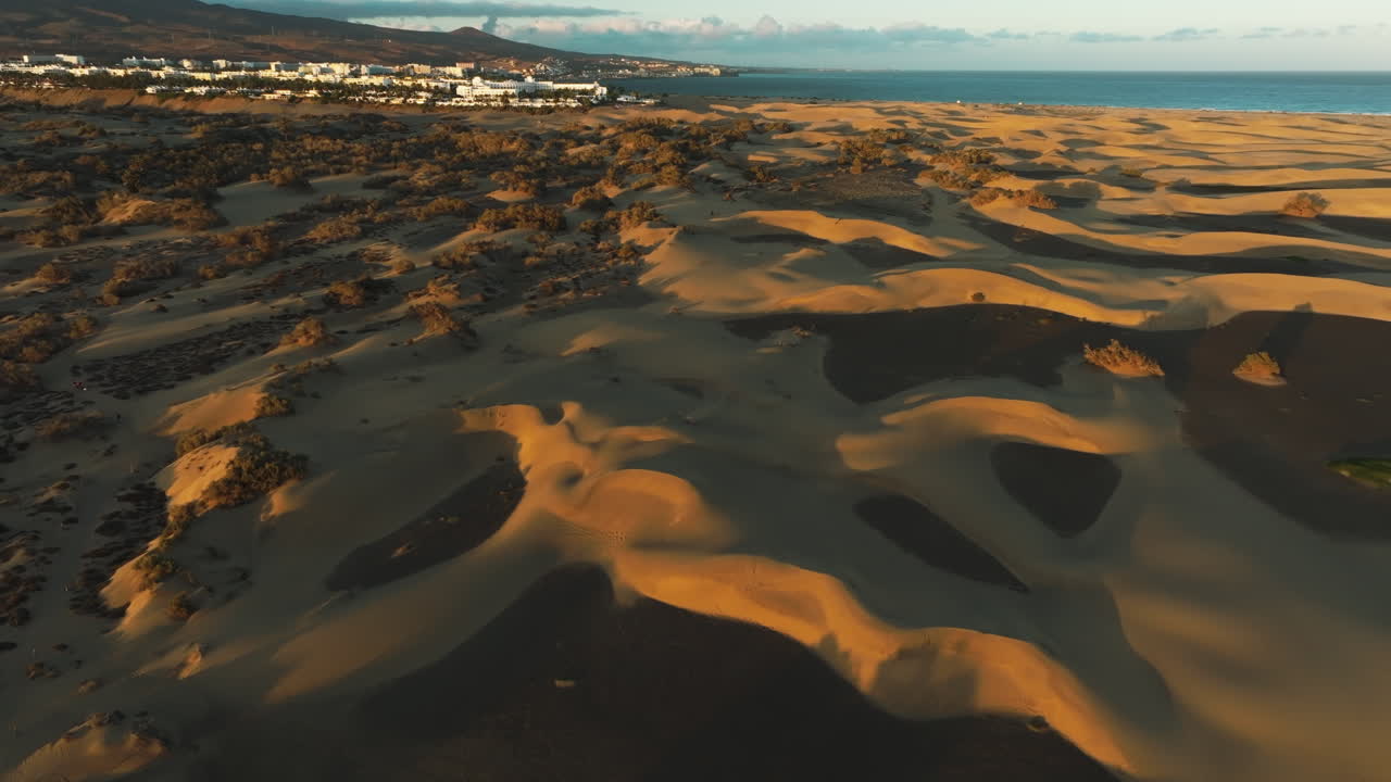 volando sobre las dunas de maspalomas durante la puesta de sol con movimientos suaves