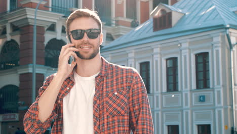 man talking on phone in city