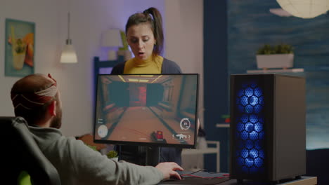 wife arguing with man gamer during space shooter videogame tournament