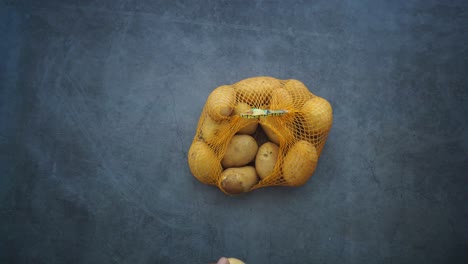 hands holding a bag of potatoes