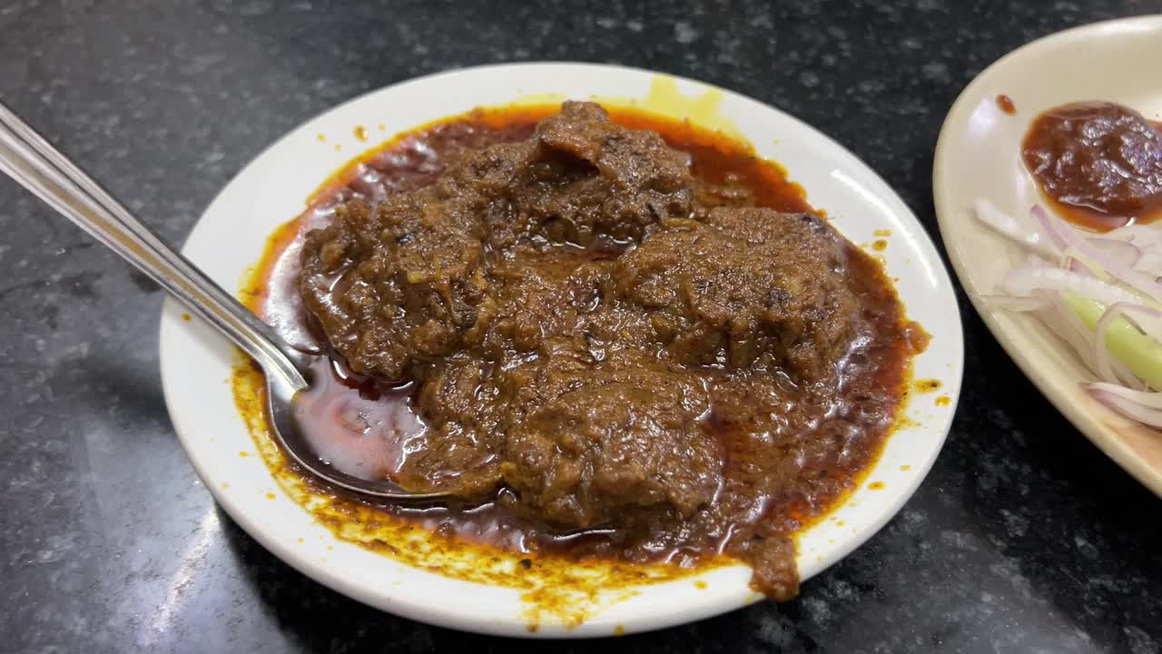 Spicy and oily mutton kossa served in a old Punjabi dhaba in Kolkata.