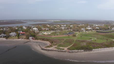 Aerial-wide-push-in-shot-of-historic-Fort-Moultrie-along-Charleston-Harbor-on-Sullivan's-Island,-South-Carolina