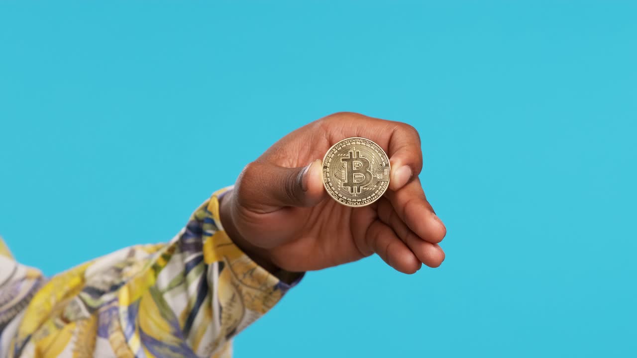Crop person showing bitcoin in hand