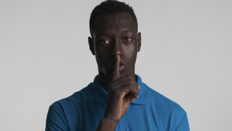 confident african american man on grey background.