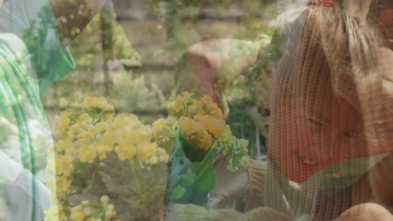 Child in cozy sweater admiring yellow flowers in garden with animation