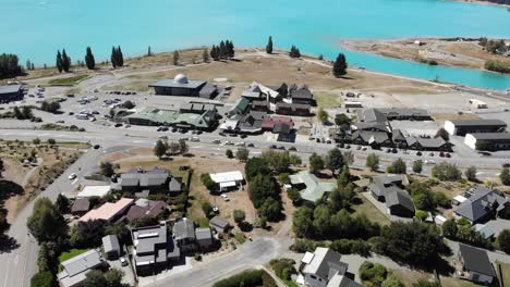 Aerial-view-of-Lake-Tekapo-village-mainstreet-with-shops,-observatory