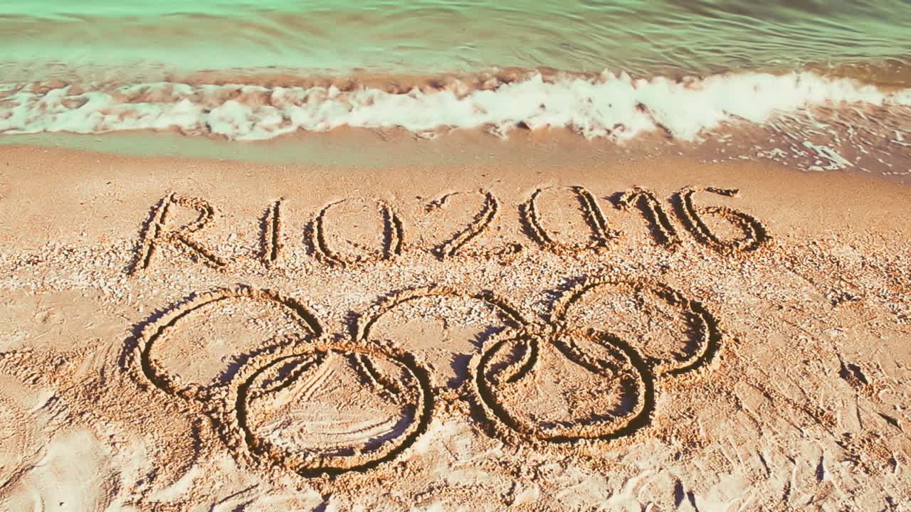 Rio 2016 an inscription on sand, the beach. Symbol Olympic game on sand, the beach
