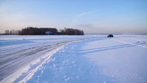 car driving on a frozen lake in winter