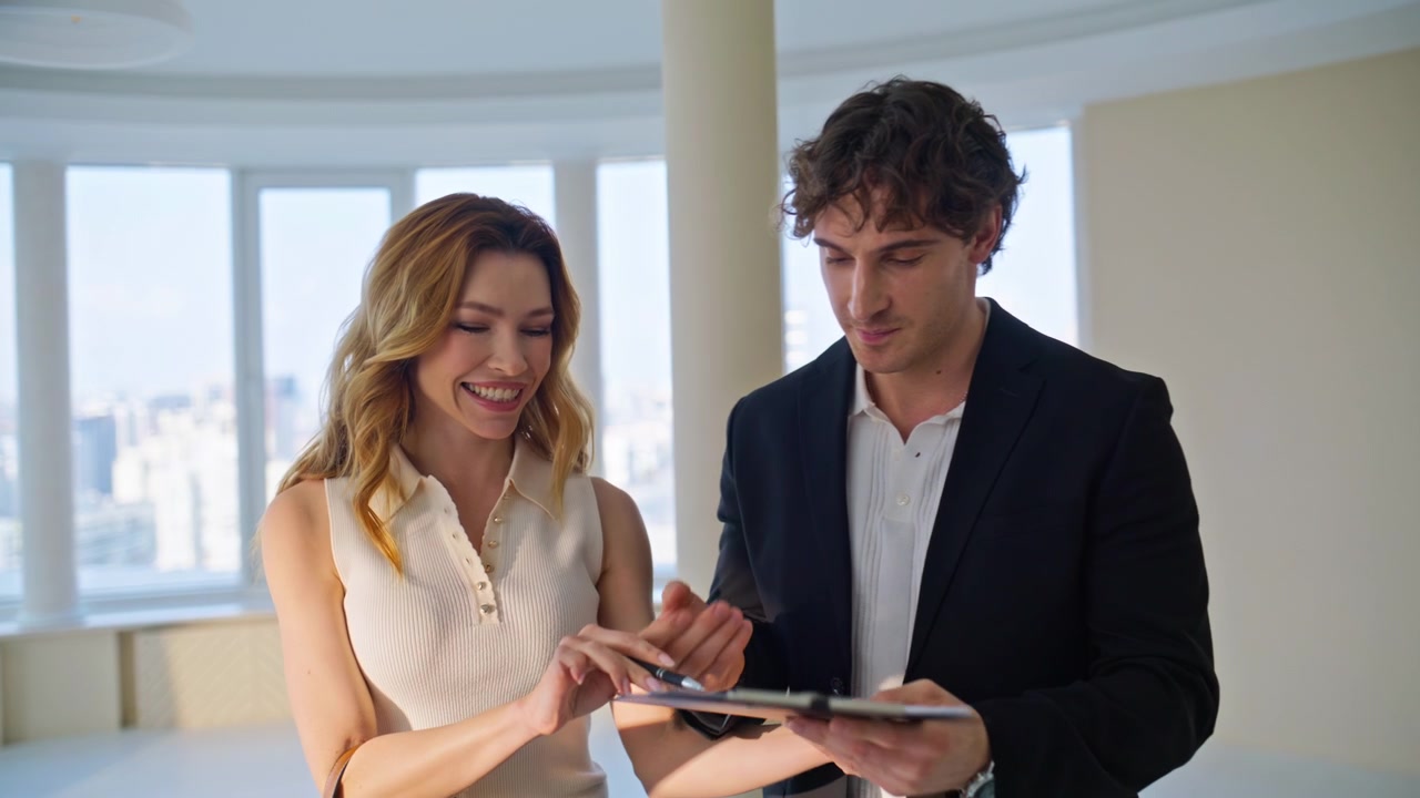 Estate agent presenting apartment client. Woman showing plan man luxury flat.