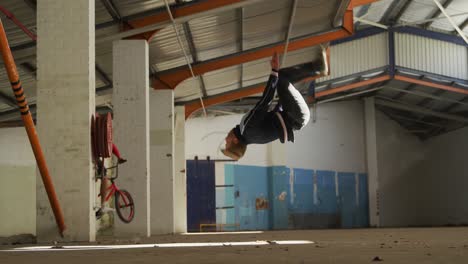 bmx rider in an empty warehouse