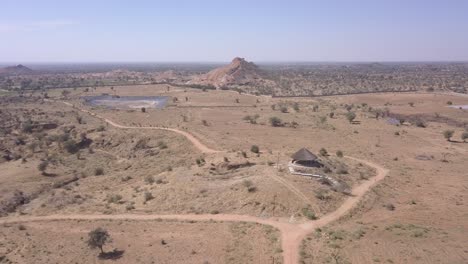 a gazebo in the middle of the barren field in rajasthan, india on a hot sunny weather - aerial