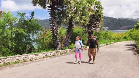 couple hiking on a tropical island trail