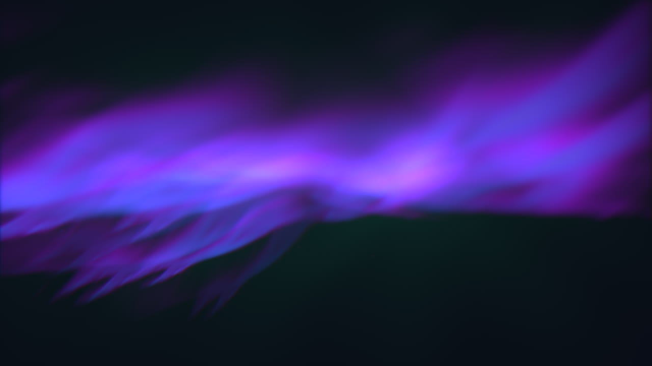 Vibrant close-up of a purple and blue flame burning in darkness, emitting smoke that rises vertically. The detailed image showcases intense hues and intricate patterns
