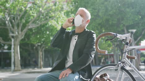 caucasian man out and about in the street wearing on a face mask against coronavirus