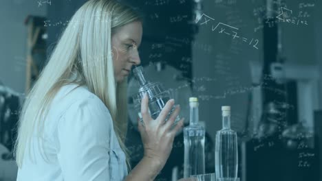 mathematical equations moving against female scientist working in laboratory