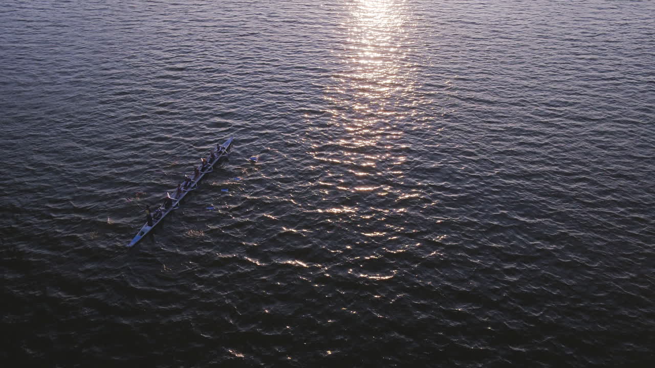 Rowing Team on the Water at Sunset