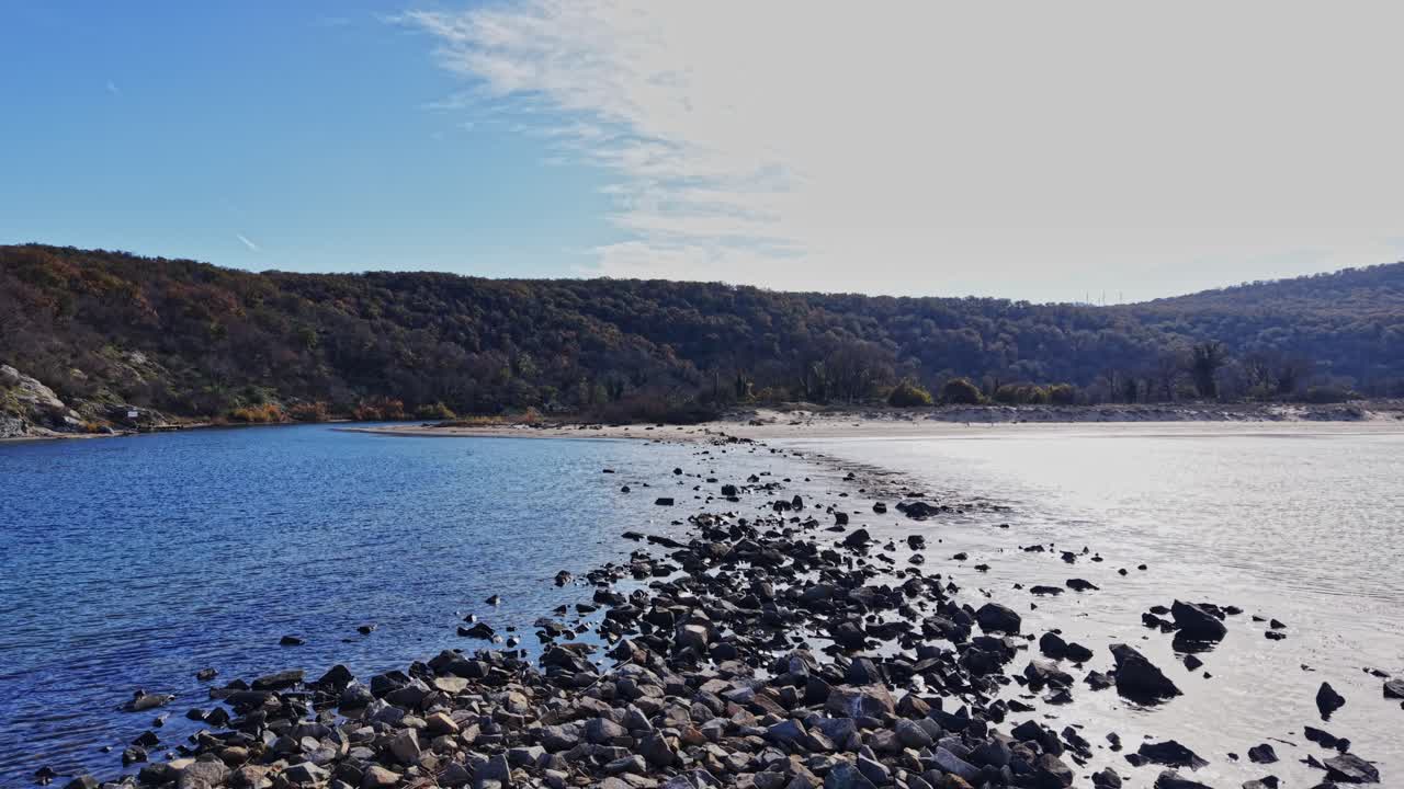 Beautiful aerial view of rocky shoreline at low tide with blue water