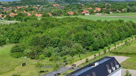 aerial view of luxurious villa zoutelande in neighborhood surrounded by green fields and sea