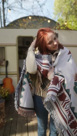 woman in a cozy blanket outdoors in autumn