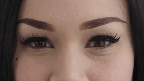 close up caucasian woman eyes opening wearing makeup looking at camera beauty cosmetics