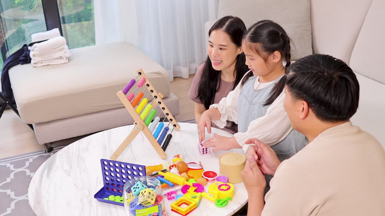A family enjoys a playful and educational moment using a wooden abacus and dice in a cozy living room