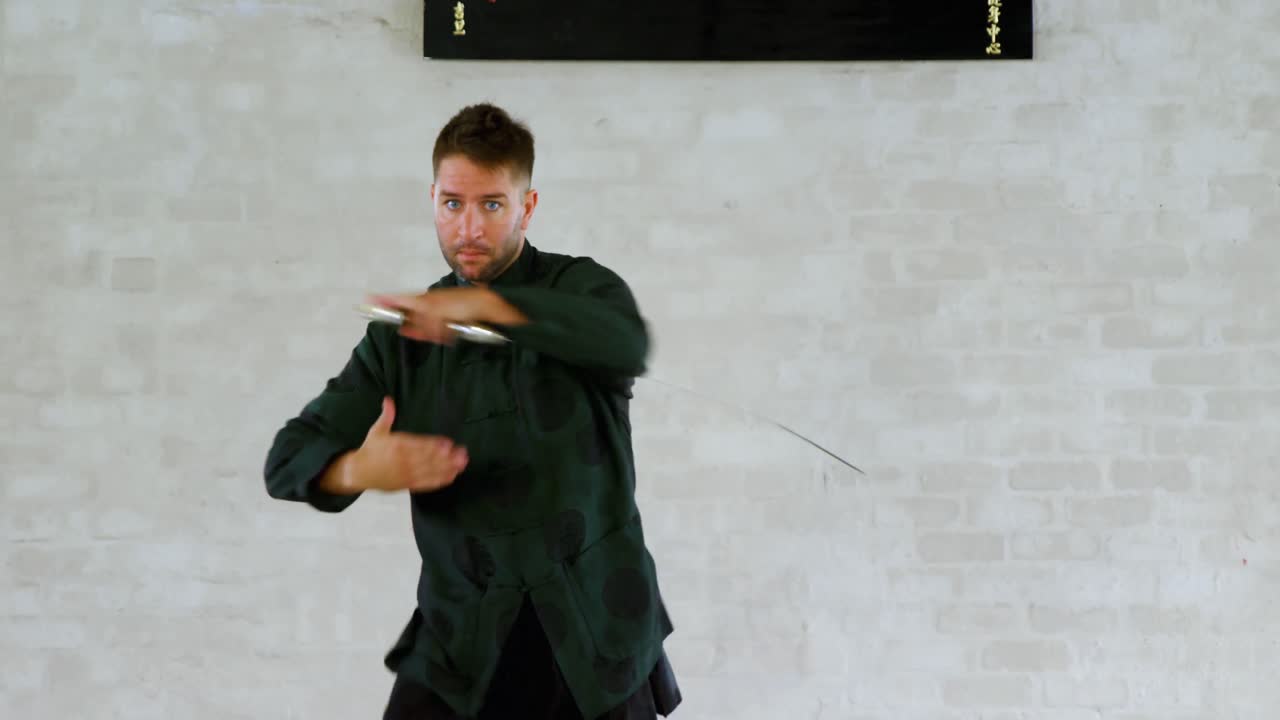 Kung fu fighter practicing martial arts with sword 4k
