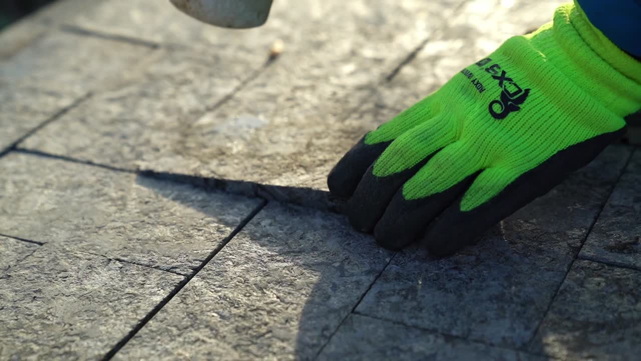 Placing the last piece of granite stone in the pavement